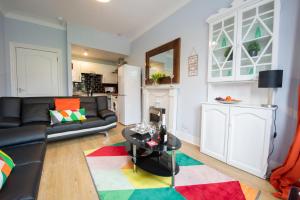 a living room with a couch and a table at PREMIER - Crathie View Apartment in Glasgow