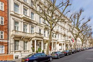 a row of cars parked in front of a building at Queensgate Court in London
