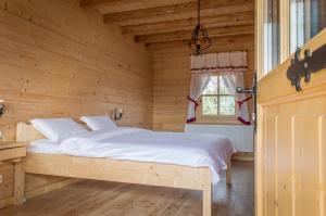 a bedroom with a bed in a wooden room at "Plai cu Peri" in Săpînţa +85 photos