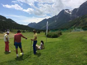 a group of people playing golf in a field at Hotel Mignon in Breuil-Cervinia