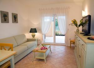 a living room with a couch and a table at Residence Dei Margi in Torre Faro