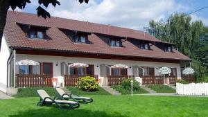 ein Haus mit zwei Gartenstühlen davor in der Unterkunft Pension Busch in Salem