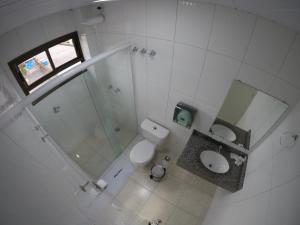 an overhead view of a bathroom with a toilet and a shower at Hotel Dove in Foz do Iguaçu