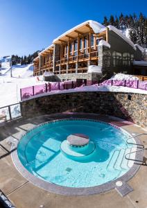 a swimming pool in front of a ski resort at Sunshine Mountain Lodge in Banff