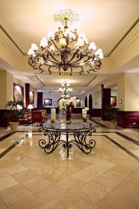 a large lobby with a large chandelier and a table at Bahia Principe Grand Cayacoa in Santa Bárbara de Samaná