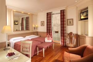 Postel nebo postele na pokoji v ubytování Hotel Villa Glori