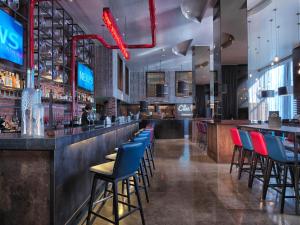a bar with blue and red chairs in a restaurant at Malmaison Birmingham in Birmingham +62 photos