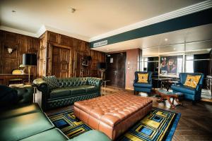 a living room with a couch and a table and chairs at Malmaison Birmingham in Birmingham