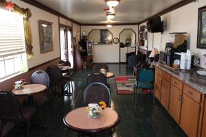 a restaurant with tables and chairs in a room at Regency Inn Eureka Springs in Eureka Springs