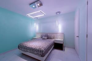 a bedroom with a bed and a sink in a room at Once21 Apartment in Guadalajara +64 photos