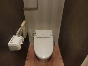 a bathroom with a white toilet in a stall at Hotel Hyper Noah (Adult Only) in Sakai