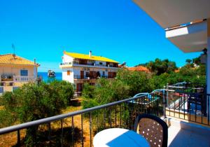 a balcony with a view of a building at Sideris Lambros Rooms in Parga