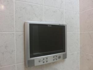 a flat screen tv on a tiled wall at Hotel Hyper Noah (Adult Only) in Sakai