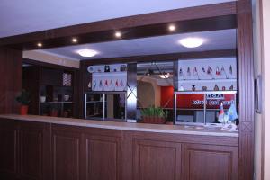 a bar in a restaurant with a large window at Astana Best Hostel in Astana
