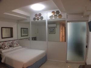Un ou plusieurs lits dans un hébergement de l'établissement Murraya Residence