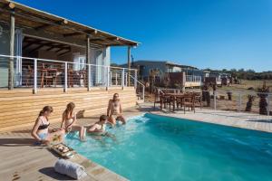 a group of people sitting in a swimming pool at Stoneyvale Cottages in Grahamstown