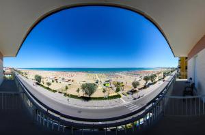 an archway in a building with a view of a beach at Hotel Tritone Rimini in Rimini