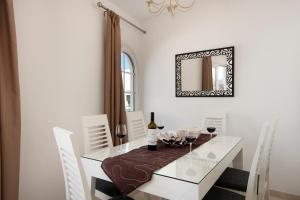 a dining room with a white table and a mirror at Apartment Old Town in Puerto del Carmen