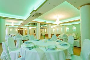 a banquet hall with white tables and chairs at Hotel Politański in Rybnik