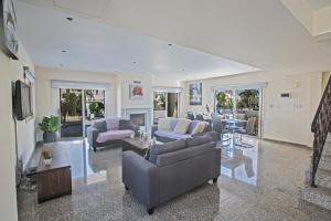 a large living room with couches and a fireplace at Delfini Villas in Protaras