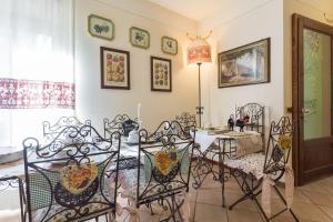 a dining room with a table and wrought iron chairs at B&B New Day in Assisi