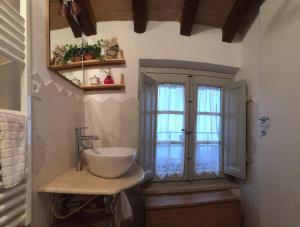 a bathroom with a sink and a window at La casina delle rondini in Corsanico-Bargecchia +33 photos