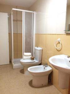 a bathroom with a shower and a toilet and a sink at Hola Apartments 1-30 in Playa de San Juan