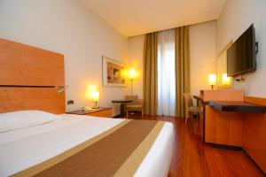 Кровать или кровати в номере Hotel Igea
