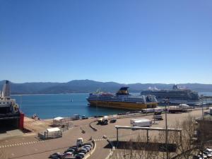 a large cruise ship is docked in a harbor at Hotel le Dauphin in Ajaccio