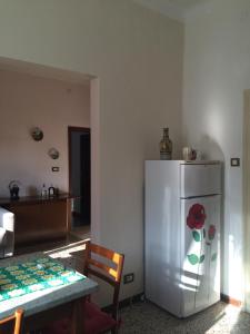 a kitchen with a table and a white refrigerator at Appartamento la Garzetta in Venice