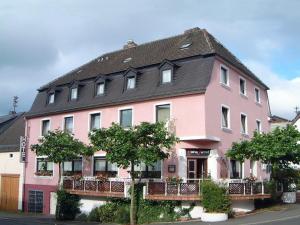 a pink house with a black roof at Hotel Westrich in Baumholder