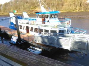 a boat is docked at a dock in the water at Esker House in Donegal