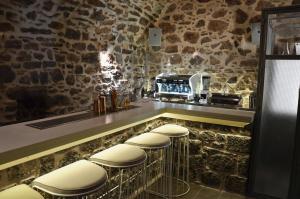 a bar with a row of stools at a counter at Lida Mary in Mestá