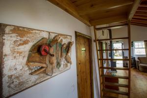 a painting hanging on a wall in a room at Caldeira Guesthouse in Fajã da Caldeira de Santo Cristo