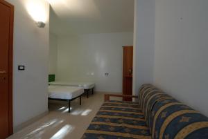 En eller flere senge i et værelse på Villaggio Camping Uria