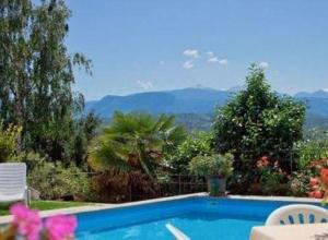 ein Schwimmbad mit Blick auf die Berge in der Unterkunft Pension Steingarten in Appiano sulla Strada del Vino
