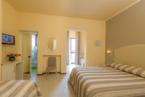 Postel nebo postele na pokoji v ubytování Hotel Gemma Del Mare