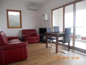 uma sala de estar com uma mesa, uma cadeira e um computador portátil em Apartment-Hotel Vila Petrovic-Becici em Budva