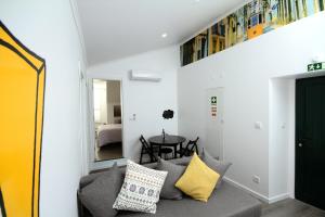 a living room with a couch and a table at Alfama Right Point in Lisbon