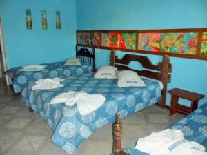 En eller flere senge i et værelse på Pousada Recanto de Minas