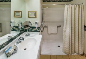 a bathroom with a white sink and a shower at Fairhaven Village Inn in Bellingham