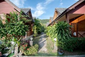 a walkway between two houses with plants at Poonsap Resort in Ko Lanta