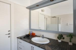 a bathroom with a sink and a mirror at Eliyahu Salman Apartment in Jerusalem