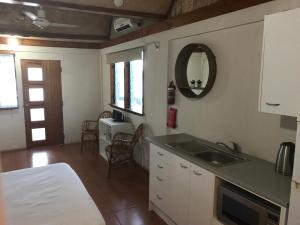 a kitchen with a sink and a counter top at Boathouse Apartments in Neiafu