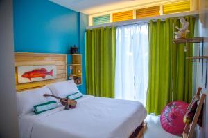 A bed or beds in a room at Flotsam and Jetsam Artist Beach Hostel