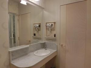 a bathroom with a sink and a mirror at Hotel Hyper Noah (Adult Only) in Sakai