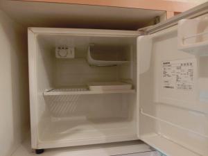 an empty refrigerator with its door open at Hotel Hyper Noah (Adult Only) in Sakai