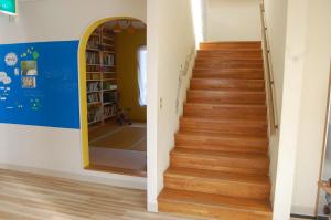 a stairway in a room with a mirror at Minshuku Namisou in Iriomote