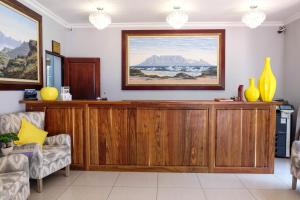 a living room with a large wooden entertainment center at Waterkloof Guest House in Pretoria