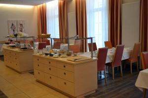 a dining room with a table and chairs at Hotel Grazerhof in Bad Gleichenberg +5 photos